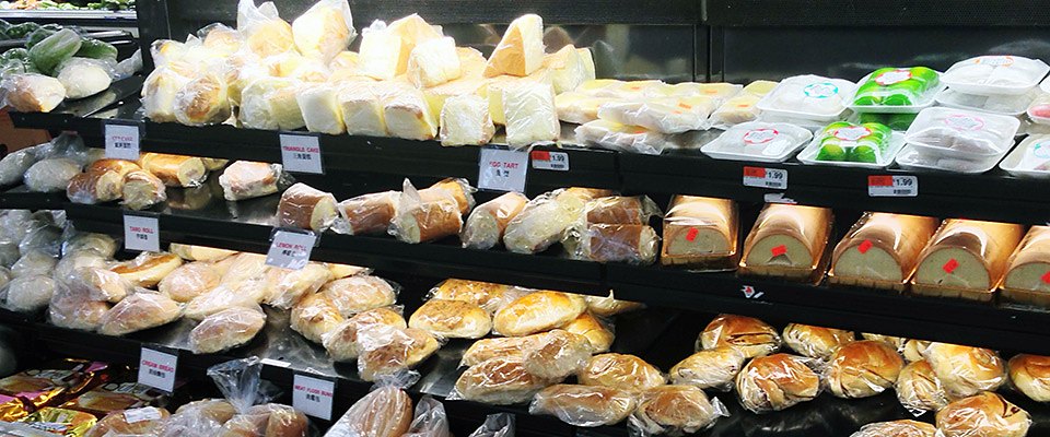 Chinese-style buns, rolls and egg tarts on the bakery shelves